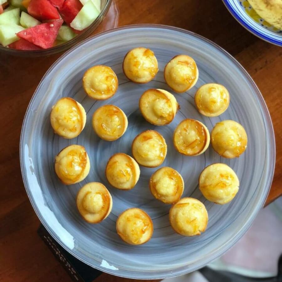 A plate of circular pastries topped with a golden creamy filling.